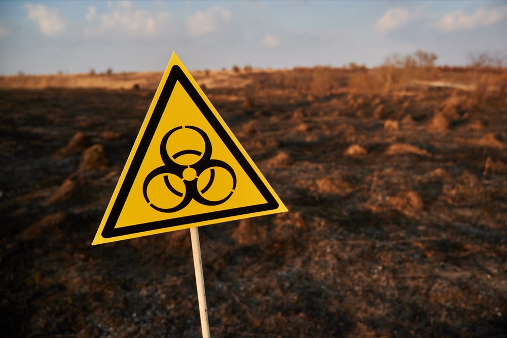 Biohazard sign in open field